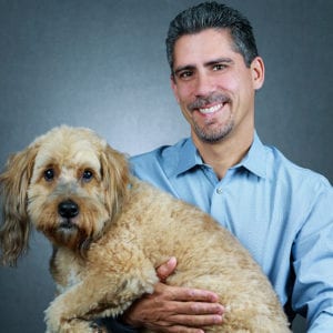 Max Freund holding a Dog